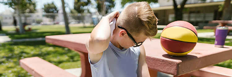 Activity therapy. Young boy opening up the therapist while playing basketball.