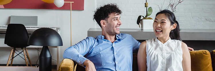 Couples therapy. Happy mixed-race couple on couch during therapy session.